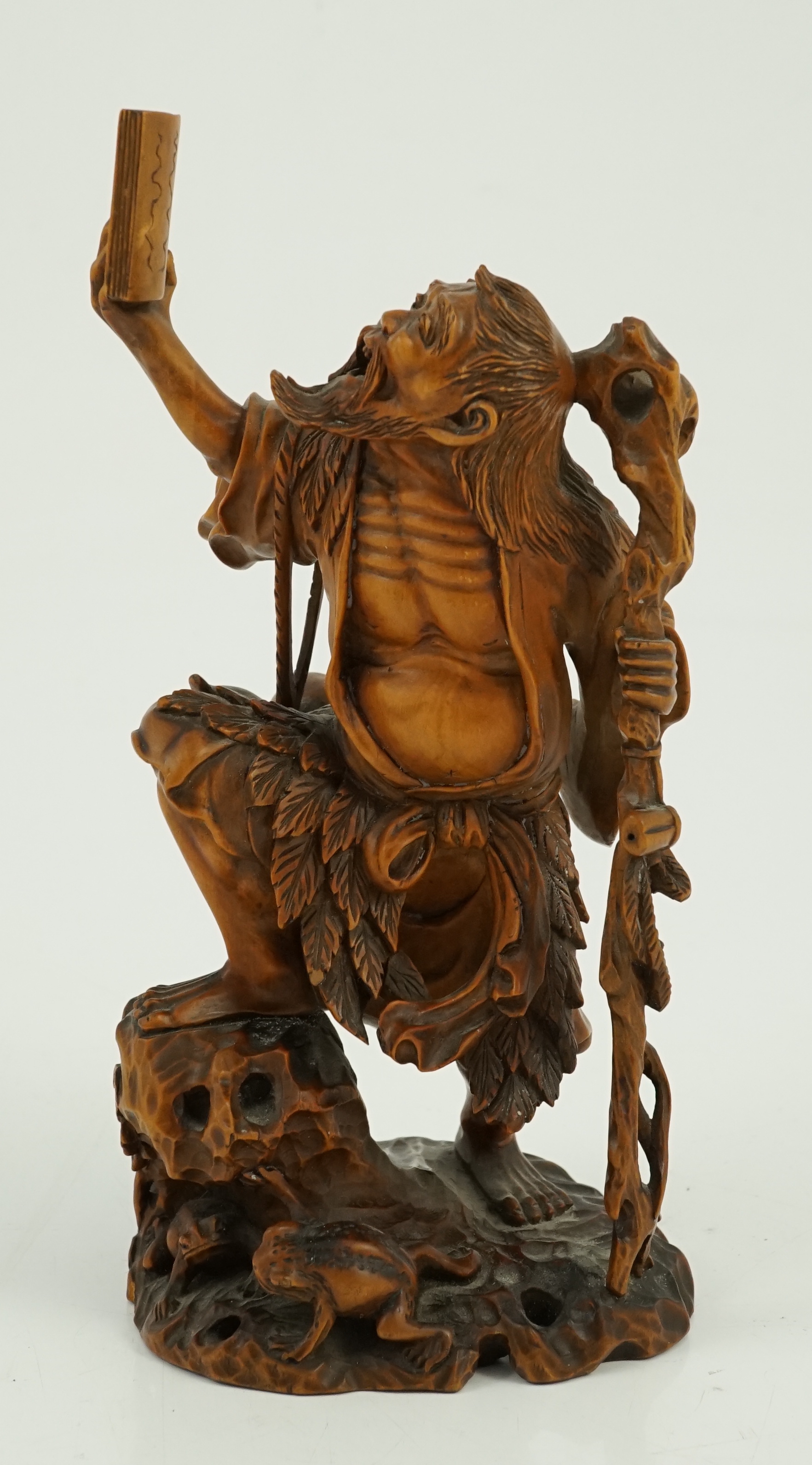 A Japanese boxwood okimono of Gama Sennin and two toads, 19th century, age crack to base